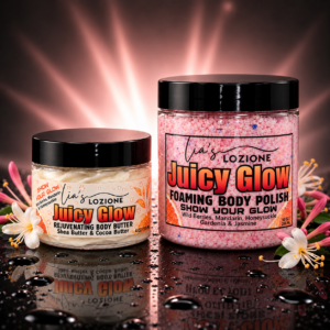 Juicy Glow 4 oz Body Butter and 10 oz Body Polish with pink rays behind the jars on a wet surfacae with Honeysuckle flowers on each side