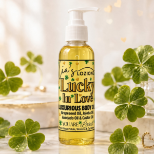 Lucky In Love 4 OZ Body Oil Bottle in a bright setting with four leaf clovers